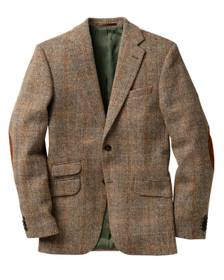 Das Zweiknopfsakko ist aus original Harris Tweed in Vorderansicht abgebildet. Die Lederflecken an den Ellbogen können leicht abgenommen werden, je nach Belieben.